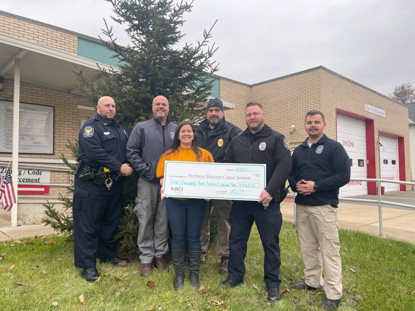 Plains Township, PA, police present check to the Northeast Regional Cancer Institute. Officer William Poulos, left, Lt. Richard Lussi, Amanda E. Marchegiani from the Northeast Regional Cancer Institute, police Chief Dale Binker, Officer Kevin Brennan, and Officer Brandyn Cole.